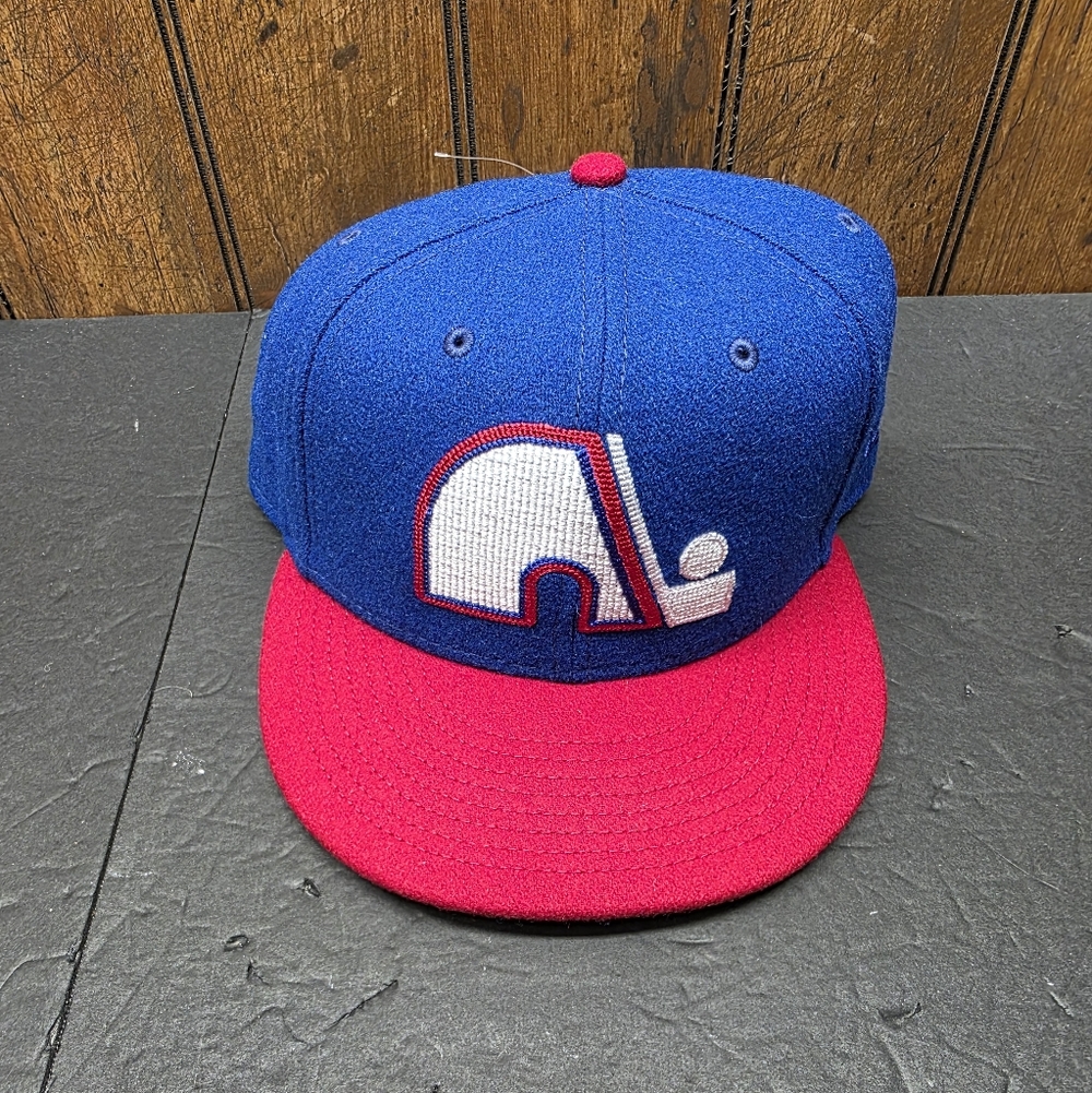 New Era 59FIFTY fitted hat in blue and red featuring the Quebec Nordiques logo. 